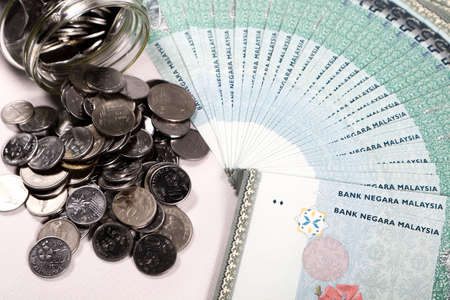 Financial concept, A malaysia ringgit coin in transparent glass bottle isolated white backgroundの写真素材