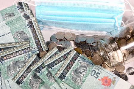 Financial concept, A malaysia ringgit coin in transparent glass bottle isolated white backgroundの写真素材