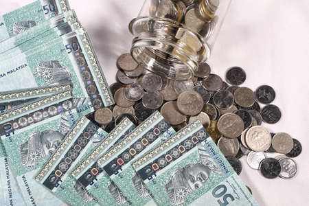 Financial concept, A malaysia ringgit coin in transparent glass bottle isolated white backgroundの写真素材