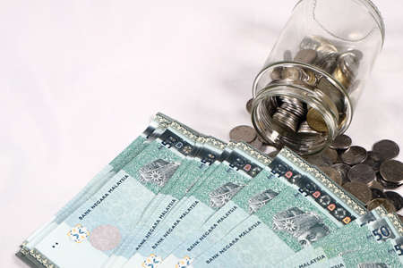 Financial concept, A malaysia ringgit coin in transparent glass bottle isolated white background