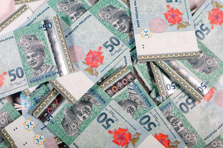 Malaysia Currency (MYR): Stack of Ringgit Malaysia bank note. There is a fifty ringgit malaysia...
