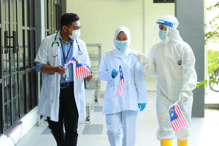 Kuala Lumpur, Malaysia : Circa July 2020 - Malaysian college students with Malaysian Flag during the celebration of Hari Kemerdekaan, the Independence Day of Malaysia.のeditorial素材