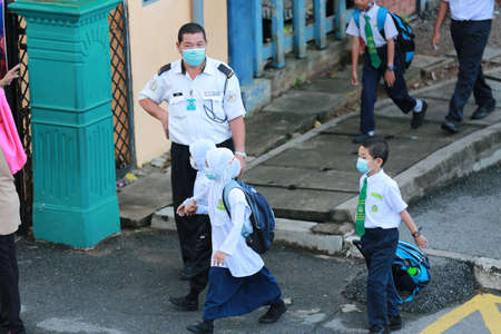 Kedah/Malaysia-September 9 2020: Students wearing face masks following restrictions to halt the...