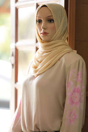 Female mannequins wearing modern batik muslim dresses and hijabs exhibited in batik workshopの写真素材