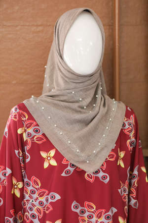 Female mannequins wearing modern batik muslim dresses and hijabs exhibited in batik workshopの写真素材