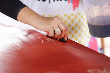 Artist paints a picture of oil paint brush in hand with palette close up.の写真素材