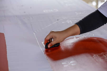 Artist paints a picture of oil paint brush in hand with palette close up.の写真素材