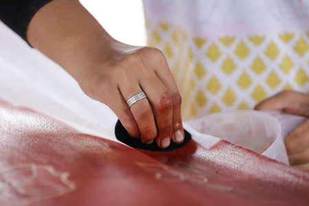 Artist paints a picture of oil paint brush in hand with palette close up.の写真素材