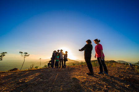 kedah, Malaysia - December 13, 2019: beautiful scenery in the morning and starburst sunrise at Bukit Laka, changlun with a groups of hikerのeditorial素材