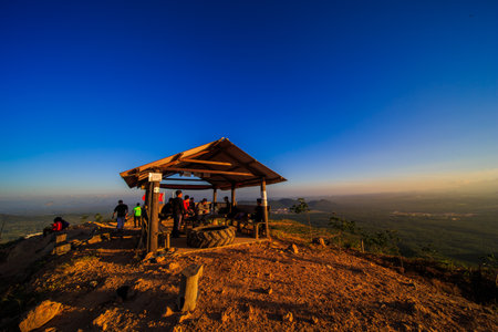 kedah, Malaysia - December 13, 2019: Hiker enjoying nature on top of mountain with sunrise, many residents around Bukit Laka, Changlun climb the hill to see the beautiful scenery in the morningのeditorial素材