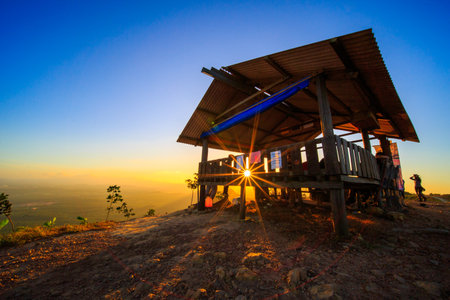 kedah, Malaysia - December 13, 2019: beautiful scenery in the morning and starburst sunrise at Bukit Laka, changlun with a groups of hikerのeditorial素材