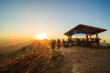 kedah, Malaysia - December 13, 2019: Hiker enjoying nature on top of mountain with sunrise, many residents around Bukit Laka, Changlun climb the hill to see the beautiful scenery in the morningのeditorial素材