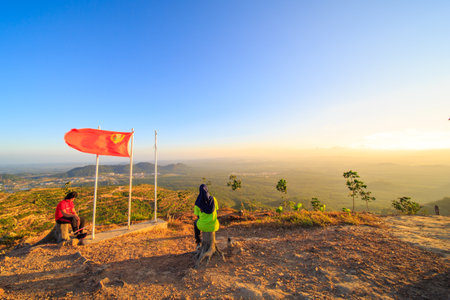 kedah, Malaysia - December 13, 2019: Hiker enjoying nature on top of mountain with sunrise, many residents around Bukit Laka, Changlun climb the hill to see the beautiful scenery in the morningのeditorial素材
