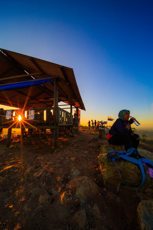 kedah, Malaysia - December 13, 2019: Hiker enjoying nature on top of mountain with sunrise, many residents around Bukit Laka, Changlun climb the hill to see the beautiful scenery in the morningのeditorial素材