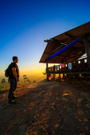 kedah, Malaysia - December 13, 2019: Hiker enjoying nature on top of mountain with sunrise, many residents around Bukit Laka, Changlun climb the hill to see the beautiful scenery in the morningのeditorial素材