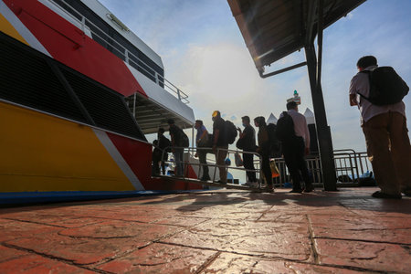 LANGKAWI,KEDAH-DECEMBER 23 2020: Crowd of unrecognizable local tourist wearing surgical mask for prevent coronavirus Outbreak  at Langkawi Jetty Point Kuahのeditorial素材