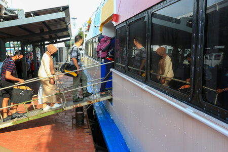 LANGKAWI,KEDAH-DECEMBER 23 2020: Crowd of unrecognizable local tourist wearing surgical mask for prevent coronavirus Outbreak  at Langkawi Jetty Point Kuahのeditorial素材