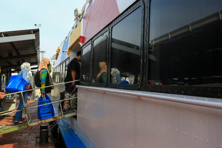 LANGKAWI,KEDAH-DECEMBER 23 2020: Crowd of unrecognizable local tourist wearing surgical mask for prevent coronavirus Outbreak  at Langkawi Jetty Point Kuahのeditorial素材