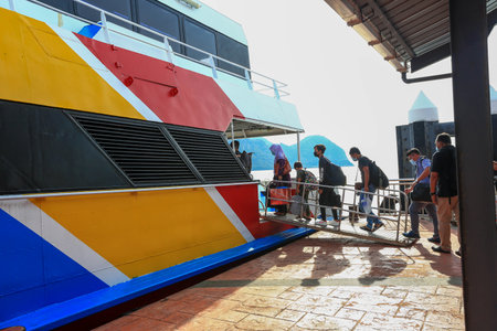 LANGKAWI,KEDAH-DECEMBER 23 2020: Crowd of unrecognizable local tourist wearing surgical mask for prevent coronavirus Outbreak  at Langkawi Jetty Point Kuahのeditorial素材