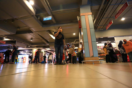 LANGKAWI,KEDAH-DECEMBER 23 2020: Crowd of unrecognizable local tourist wearing surgical mask for...