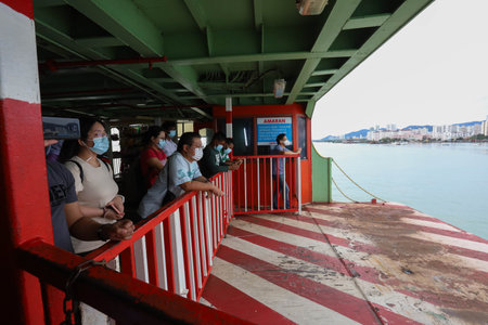 Pulau Pinang , Malaysia - Dec 19 2020: Crowd of unrecognizable local tourist wearing surgical mask for prevent coronavirus Outbreak at Butterworth ferry terminal to Penang islandのeditorial素材