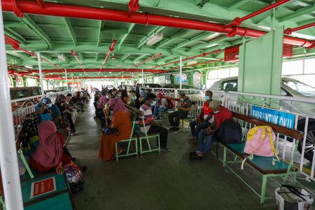 Pulau Pinang , Malaysia - Dec 19 2020: Crowd of unrecognizable local tourist wearing surgical mask for prevent coronavirus Outbreak at Butterworth ferry terminal to Penang islandのeditorial素材