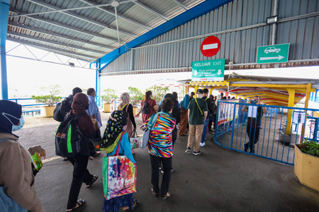 Pulau Pinang , Malaysia - Dec 19 2020: Crowd of unrecognizable local tourist wearing surgical mask for prevent coronavirus Outbreak at Butterworth ferry terminal to Penang islandのeditorial素材