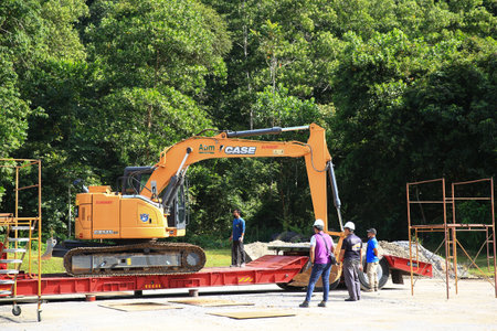 Sintok,Kedah Malaysia - Circa November 2020 : Case Excavator cx-125 uploading process on trailer...