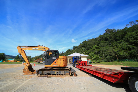 Sintok,Kedah Malaysia - Circa November 2020 : Case Excavator cx-125 uploading process on trailer trucks. The Case Corporation was a manufacturer of construction equipment and agricultural equipment.のeditorial素材