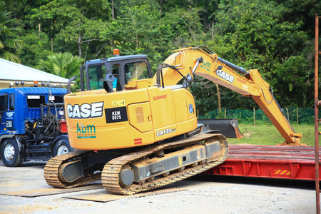 Sintok,Kedah Malaysia - Circa November 2020 : Case Excavator cx-125 uploading process on trailer trucks. The Case Corporation was a manufacturer of construction equipment and agricultural equipment.のeditorial素材