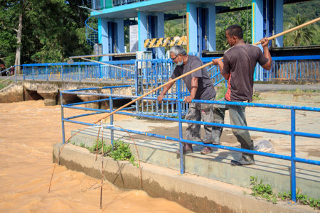 Alor Setar, Kedah, Malaysia - 19 sept 2020: Fisherman use square dip net fishing  at the river lifestyles country in Malaysia slow lifestyle.のeditorial素材