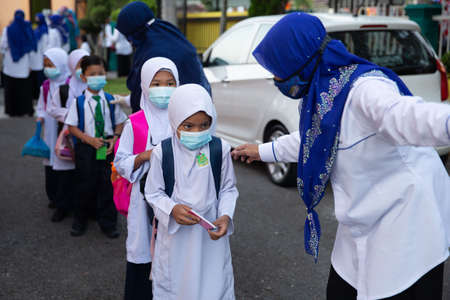 Alor Setar Kedah,Malaysia-March 1,2021:The first day of the school session for preschool students in Alor Setar during the Covid-19 pandemic season is hitting the world.のeditorial素材