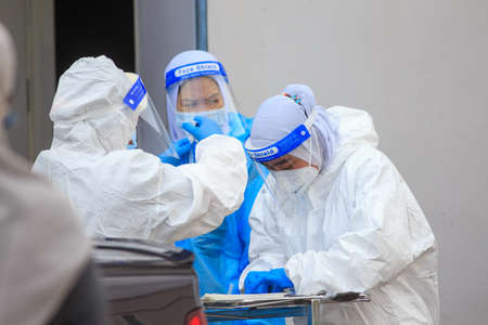 Alor Setar, Kedah, Malaysia - May 20, 2021 : Private clinic make a Swab test in  to local citizen due to Covid-19 positive cases raised up. Selective focus image with noise effectのeditorial素材