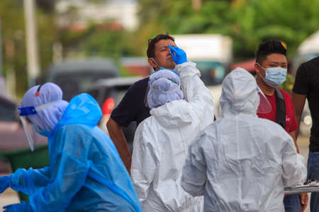 Alor Setar, Kedah, Malaysia - May 20, 2021 : Private clinic make a Swab test in  to local citizen due to Covid-19 positive cases raised up. Selective focus image with noise effectのeditorial素材