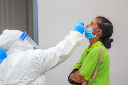 Alor Setar, Kedah, Malaysia - May 20, 2021 : Private clinic make a Swab test in  to local citizen due to Covid-19 positive cases raised up. Selective focus image with noise effectのeditorial素材