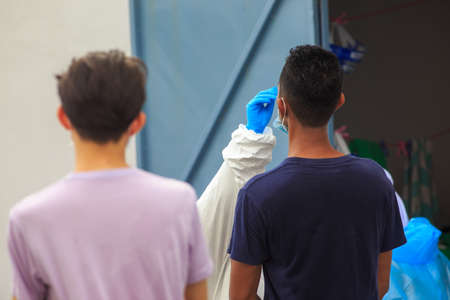 Alor Setar, Kedah, Malaysia - May 20, 2021 : Private clinic make a Swab test in  to local citizen due to Covid-19 positive cases raised up. Selective focus image with noise effectのeditorial素材