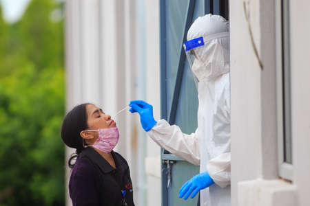 Alor Setar, Kedah, Malaysia - May 20, 2021 : Private clinic make a Swab test in  to local citizen due to Covid-19 positive cases raised up. Selective focus image with noise effectのeditorial素材