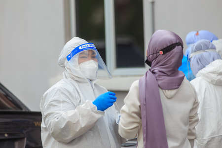 Alor Setar, Kedah, Malaysia - May 20, 2021 : Private clinic make a Swab test in  to local citizen due to Covid-19 positive cases raised up. Selective focus image with noise effectのeditorial素材