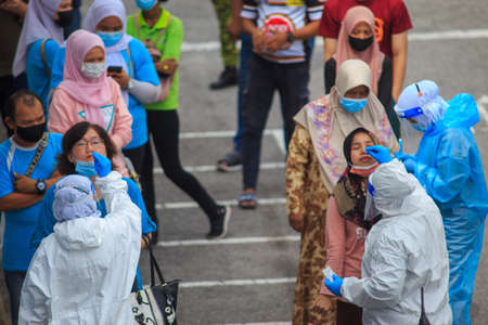 Alor Setar, Kedah, Malaysia - May 20, 2021 : Private clinic make a Swab test in  to local citizen due to Covid-19 positive cases raised up. Selective focus image with noise effectのeditorial素材
