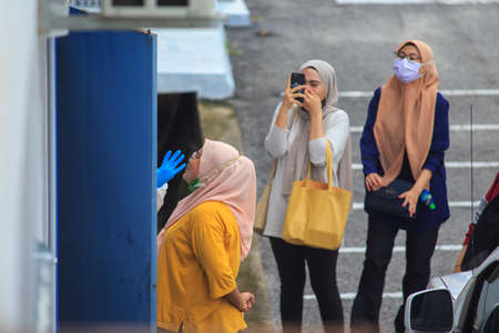 Alor Setar, Kedah, Malaysia - May 20, 2021 : Private clinic make a Swab test in  to local citizen due to Covid-19 positive cases raised up. Selective focus image with noise effectのeditorial素材