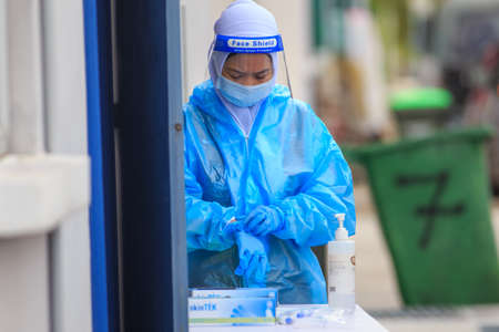 Alor Setar, Kedah, Malaysia - May 20, 2021 : Private clinic make a Swab test in  to local citizen due to Covid-19 positive cases raised up. Selective focus image with noise effectのeditorial素材