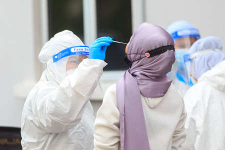 Alor Setar, Kedah, Malaysia - May 20, 2021 : Private clinic make a Swab test in  to local citizen due to Covid-19 positive cases raised up. Selective focus image with noise effectのeditorial素材