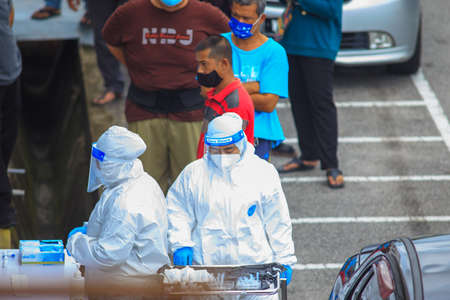 Alor Setar, Kedah, Malaysia - May 20, 2021 : Private clinic make a Swab test in  to local citizen due to Covid-19 positive cases raised up. Selective focus image with noise effectのeditorial素材