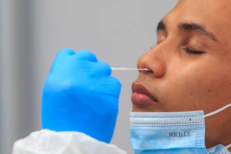 Alor Setar, Kedah, Malaysia - May 20, 2021 : Private clinic make a Swab test in  to local citizen due to Covid-19 positive cases raised up. Selective focus image with noise effectのeditorial素材