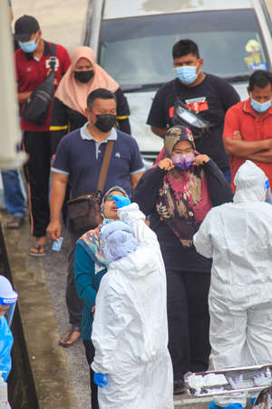 Alor Setar, Kedah, Malaysia - May 20, 2021 : Private clinic make a Swab test in  to local citizen due to Covid-19 positive cases raised up. Selective focus image with noise effectのeditorial素材