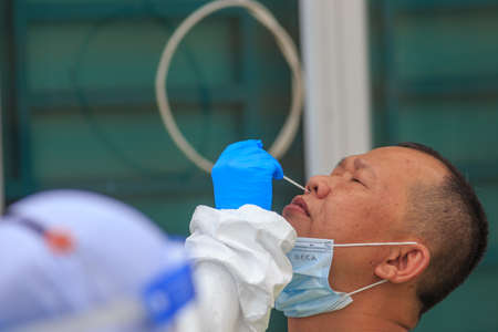 Alor Setar, Kedah, Malaysia - May 20, 2021 : Private clinic make a Swab test in  to local citizen due to Covid-19 positive cases raised up. Selective focus image with noise effectのeditorial素材