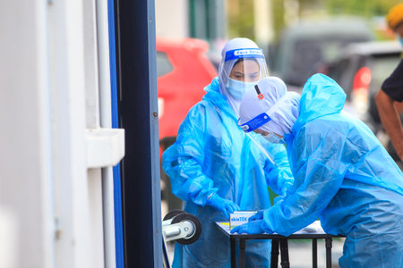 Alor Setar, Kedah, Malaysia - May 20, 2021 : Private clinic make a Swab test in  to local citizen due to Covid-19 positive cases raised up. Selective focus image with noise effectのeditorial素材