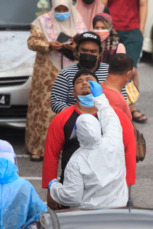 Alor Setar, Kedah, Malaysia - May 20, 2021 : Private clinic make a Swab test in  to local citizen due to Covid-19 positive cases raised up. Selective focus image with noise effectのeditorial素材