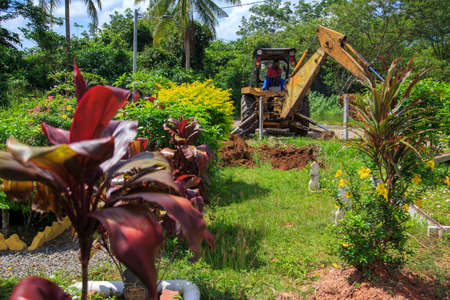 Kedah, Malaysia -May 20, 2021: A man making a grave for funeral at Muslim cemetery.のeditorial素材