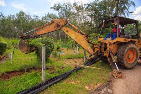 Kedah, Malaysia -May 20, 2021: A man making a grave for funeral at Muslim cemetery.のeditorial素材